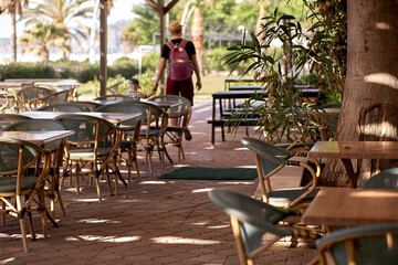 Father and son walking through the beach bar, having time together in sunny weather. Father's day concept. Family time together
