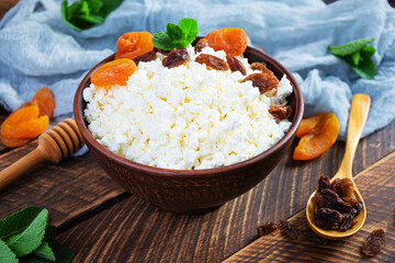 Healthy breakfast cottage cheese with raisins, dried apricots, almond, cashew and mint