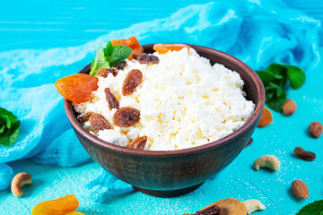 Healthy breakfast cottage cheese with raisins, dried apricots, almond, cashew and mint