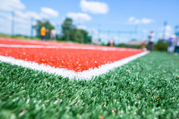 Sport ground. Universal court with artificial turf for ball games, namely: volleyball, badminton and tennis. Synthetic fiber compacted with quartz sand.