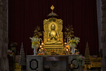 Varanasi, India: Golden statue of sitting Buddha in meditation at the Buddhist temple Mulagandhakuti vihara, Sarnath, Varanasi, India