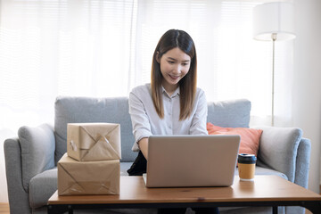 Asian woman working from home, SME business owner, Online marketing and delivery.