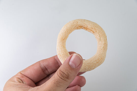 Brazilian food - biscoito de polvilho on the white background - man holding