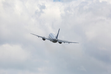 Fototapeta na wymiar Passenger plane flying in cloudy sky