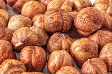 Few peeled hazelnuts with a textured skin