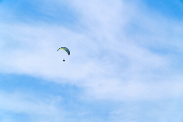 Paragliding in the blue sky. Man flying high