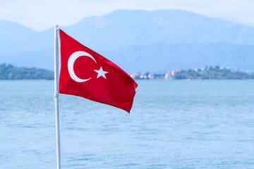Turkish national flag on the blue sea background