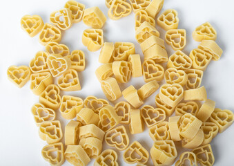 Raw Italian pasta fettuccine, amorini, paccheri, farfalle, spaghetti, fusilli, penne, conchiglie isolated on a white background. Top view