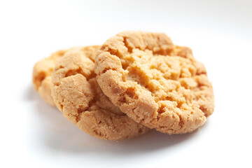 Close-up of delicious freshly baked simple cookies or biscuits. Isolated over studio white background
