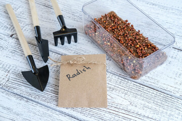 Micro green radish seeds in plastic container. Micro green seeds are sown on a coconut mat....