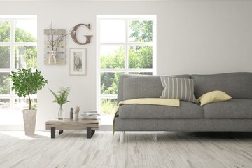 Minimalist living room in white color with sofa and summer landscape in window. Scandinavian interior design. 3D illustration