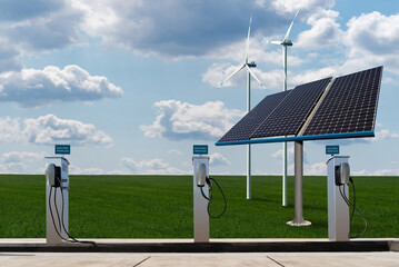 Charging stations for electric vehicles on a background of solar panels and wind turbines