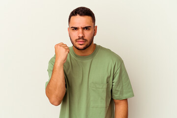 Young caucasian man isolated on white background showing fist to camera, aggressive facial...