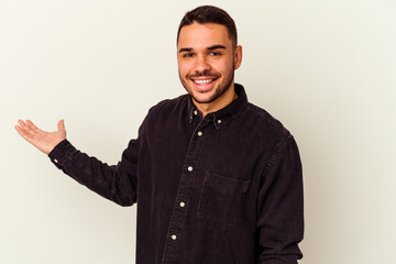 Young caucasian man isolated on white background showing a welcome expression.