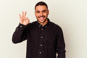 Young caucasian man isolated on white background cheerful and confident showing ok gesture.