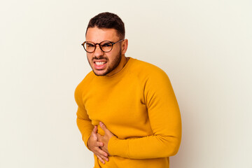 Young caucasian man isolated on white background having a liver pain, stomach ache.