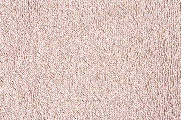 Closeup of a light pink towel. Textile details backdrop