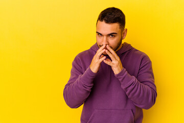 Young caucasian man isolated on yellow background making up plan in mind, setting up an idea.