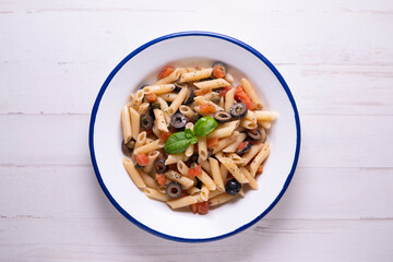 Sicilian pasta with tomato and black olives.