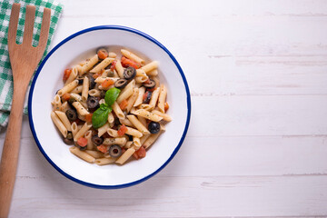 Sicilian pasta with tomato and black olives.