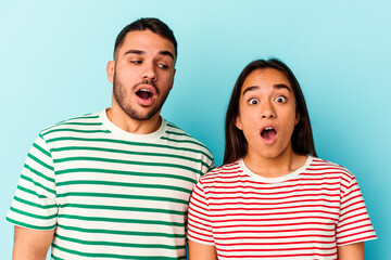 Fototapeta premium Young mixed race couple isolated on blue background