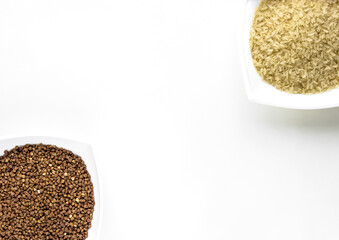 close up of white cups of buckwheat and rice layout on white isolated background. asian food and kitchen concept 
