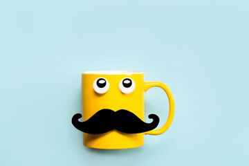Happy Father's Day.Yellow mug with mustache and funny eyes looking up and copy space