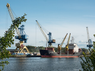 Fototapeta premium Caen, France May 2021. Unloading of a ship under the Russian flag Mekhanik Brilin, French port of unloading on the Canal de Caen. 4k high definition movie
