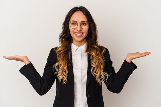 Young Mexican Business Woman Isolated On White Background Makes Scale With Arms, Feels Happy And Confident.