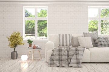 White living room with sofa and summer landscape in window. Scandinavian interior design. 3D illustration