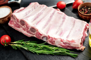 raw pork ribs on a stone background