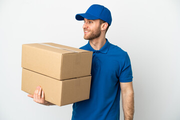 Delivery man over isolated white background looking side
