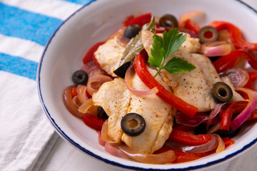 Grilled white fish with red peppers and onion. Traditional tapa from southern Spain.