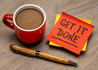 get it done advice or reminder handwriting on a sticky note with a cup of coffee, business, productivity and personal development concept