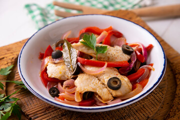 Grilled white fish with red peppers and onion. Traditional tapa from southern Spain.