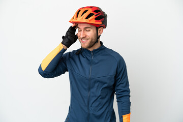 Young cyclist man isolated on white background smiling a lot