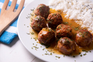 Tapa of meatballs with homemade sauce in a Spanish restaurant.