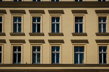 Fototapeta na wymiar windows on old residential building facade, real estate exterior -