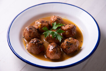 Tapa of meatballs with homemade sauce in a Spanish restaurant.