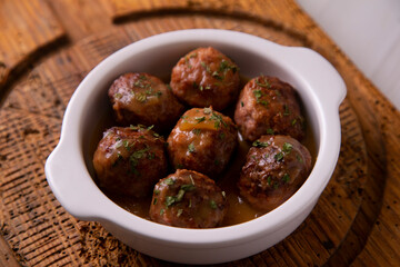 Tapa of meatballs with homemade sauce in a Spanish restaurant.