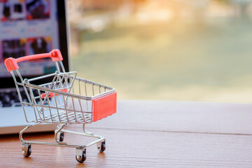 Shopping online. Shopping cart or trolley on laptop keyboard. Shopping service on The online web....