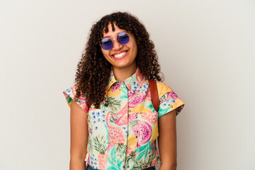 Young mixed race woman wearing sunglasses taking a vacation isolated happy, smiling and cheerful.