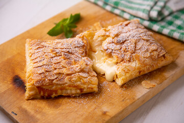 Puff pastry with custard and rolled almonds. Traditional Spanish cuisine dessert.