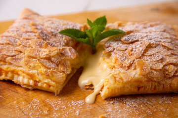 Puff pastry with custard and rolled almonds. Traditional Spanish cuisine dessert.