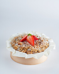Baked strawberry mini crumble cake on recycle Mini Wooden Baking Mold, white background, copy...