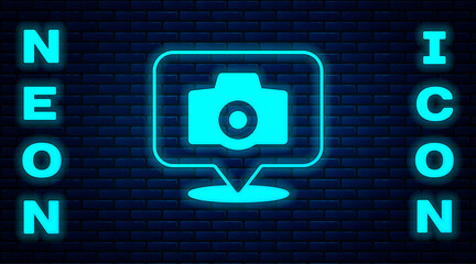 Glowing neon Photo camera icon isolated on brick wall background. Foto camera. Digital photography. Vector