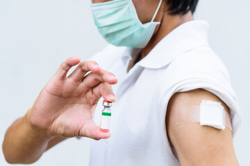 asian man wear mask and get vaccinated of covid-19