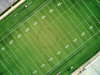 An aerial view of a football field showing the yard lines.