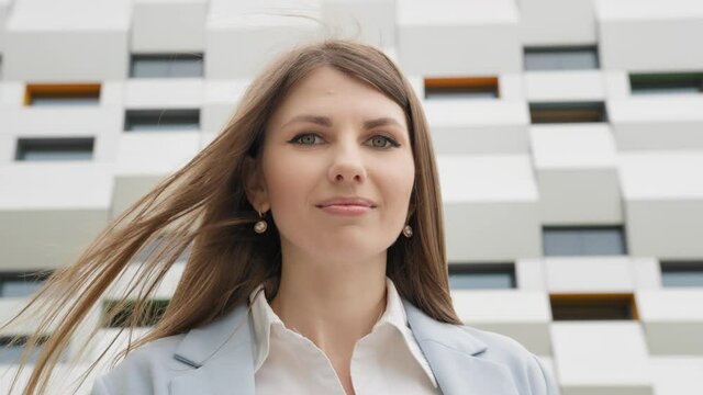 Close-up portrait of nice-looking beautiful businessperson elegant young woman looking into camera. Career people. Fashion, Female portraits. Girl with a phone in his hands smiling at the camera