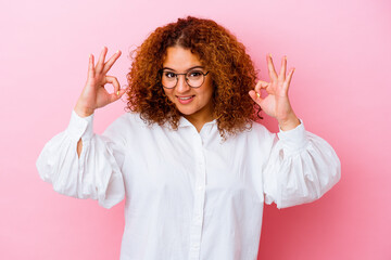 Young latin curvy woman isolated on pink background cheerful and confident showing ok gesture.
